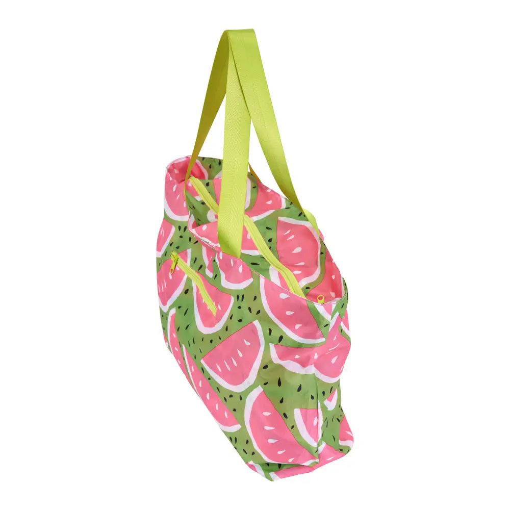 The ROCKFLOWERPAPER Watermelon Splash Proof Beach Bag, featuring green handles, a vibrant watermelon slice design on a green background, and a front zip pocket, is perfect for keeping essentials dry on your next beach outing.