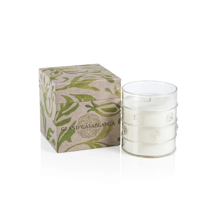 The ZODAX GRAND CASABLANCA CANDLE - WILD TUBEROSE, 12 OZ fills the room with a warm glow and wild tuberose scent in a clear, textured glass holder—perfect for a cozy ambiance or pairing with a botanical gift box.