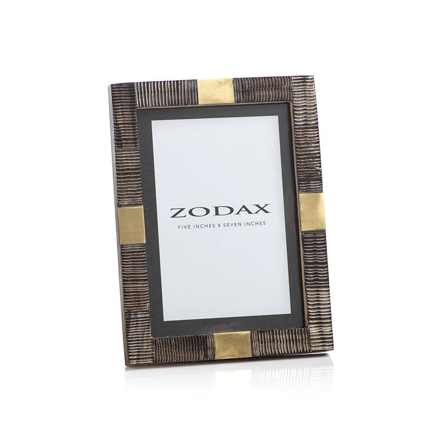 The ZODAX LAGOS HARN AND BRASS PHOTO FRAME 5x7 features textured dark brown and gold accents with a &quot;ZODAX, Five Inches x Seven Inches&quot; insert, adding elegance to your decor.