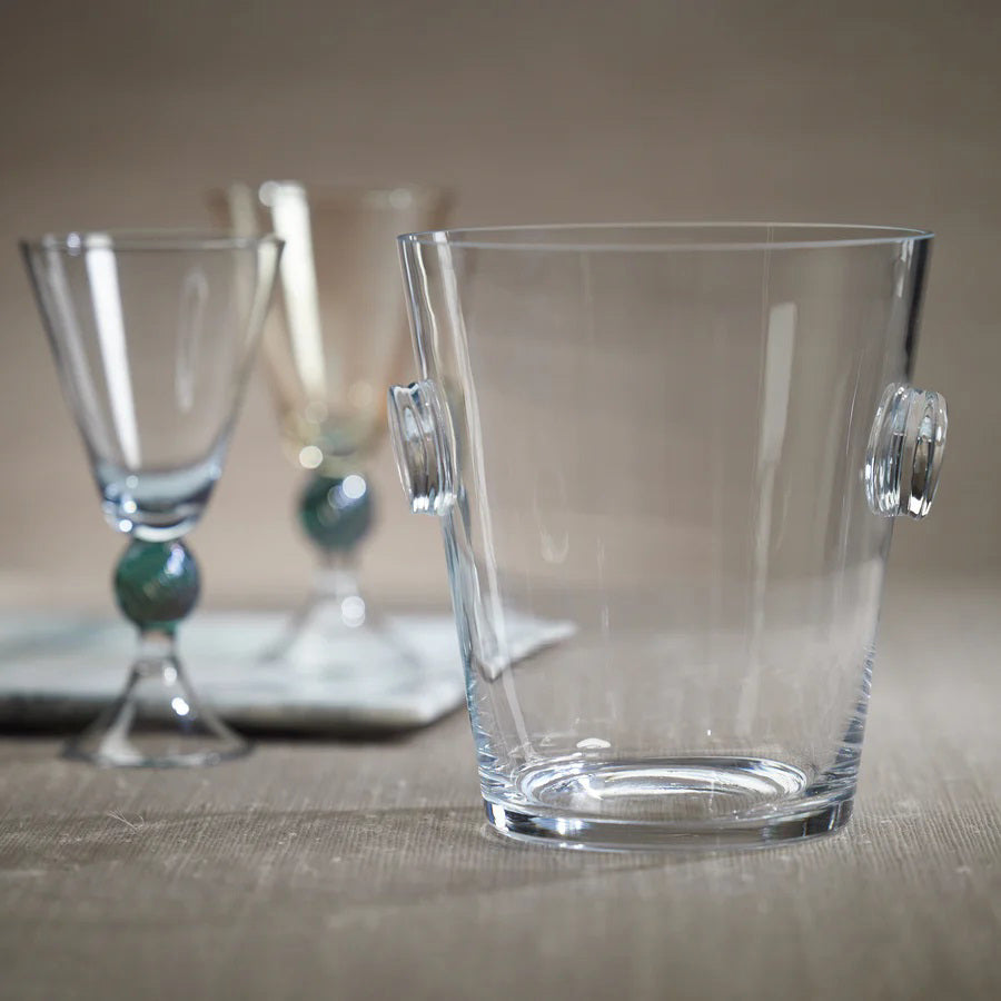The LA SERENA BEVELED GLASS ICE BUCKET by ZODAX, featuring two round glass handles on either side, measures 17.78 cm x 19.69 cm and is placed empty against a plain white background.