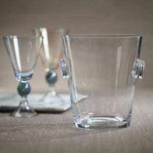 The LA SERENA BEVELED GLASS ICE BUCKET by ZODAX, featuring two round glass handles on either side, measures 17.78 cm x 19.69 cm and is placed empty against a plain white background.