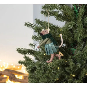 ABBOTT SKATING MOUSE ORNAMENT made of wool felt, wearing a green sweater, dark green scarf, and metallic skirt, holding a white snowflake while wearing wooden ice skates.
