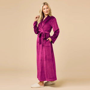 A person wearing a beige SOFTIES - SERENITY WRAP ROBE featuring a wrap silhouette with a tie waist and side pockets.