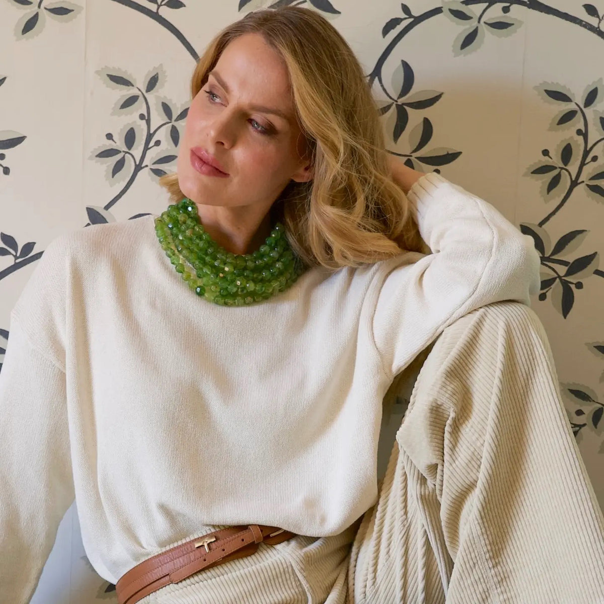 The FAIRCHILD BALDWIN - THE BELLA NECKLACE showcases layered strands of iridescent green Italian resin beads with a faceted design for a shimmering effect, finished with a smooth light green clasp that complements its vibrant hues.