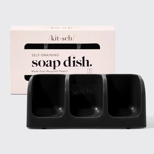 Eco-friendly KITSCH self-draining soap dish, crafted from recycled plastic with three compartments. Displayed in front of its packaging labeled "KITSCH - SELF DRAINING SOAP DISH".
