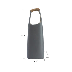 The CREATIVE COOP STONEWARE VASE WITH RATTAN WRAPPED HANDLE, GREY, stands tall with a matte finish and elongated oval opening, making a striking decorative centerpiece against a white background.