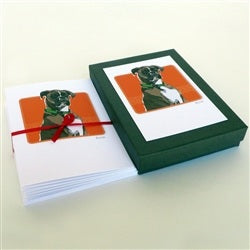 The PAPER RUSSELLS - BOXER NOTE CARDS by PAPER RUSSELLS feature a brown and white boxer dog with a green collar on an orange background, framed in black with a white mat and printed on eco-friendly recycled paper.