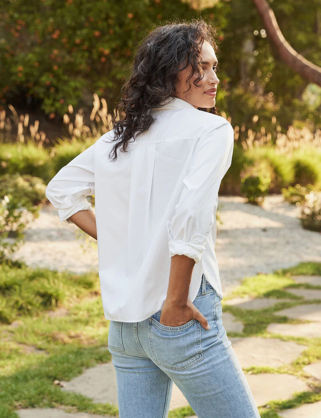 The FRANK &amp; EILEEN Silvio Untuckable Button-Up Shirt in Superluxe Cotton, featuring a chest pocket and rolled-up sleeves, is laid flat on a textured surface. The inside label reads "Frank &amp; Eileen EST 1947.