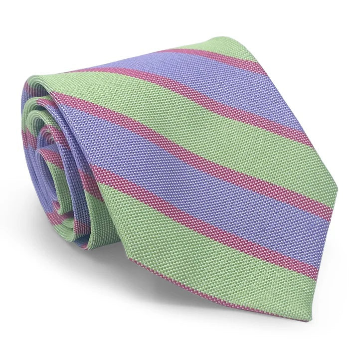 Close-up of the BIRD DOG BAY PETER-BLAIR Beaufort woven silk tie in green, featuring diagonal lavender stripes with thin red accents and a textured, handmade-in-New-York look.