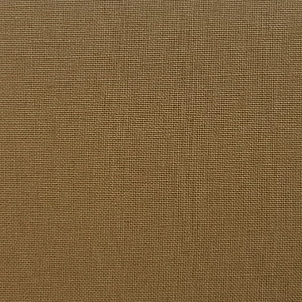 A person is seen from behind wearing MEIMEIJ&#39;s Pull On Cotton Pant, featuring an elastic waistband for comfort. The loose-fitting brown pants with large back pockets are paired with a white top peeking out at the waist, standing on a light surface.