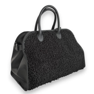 The VICARIO CINQUE - BORUSSIA HANDBAG by VICARIO CINQUE is shown on a white background, featuring a black bouclé-textured exterior on the sides and smooth leather handles.