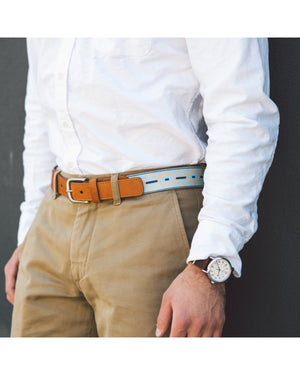 The LA MATERA - PINAMAR WOVEN BELT by LA MATERA features a full-grain leather strap, a silver buckle, and a beaded pattern in light blue, navy, and beige, offering durable premium craftsmanship and lasting style.