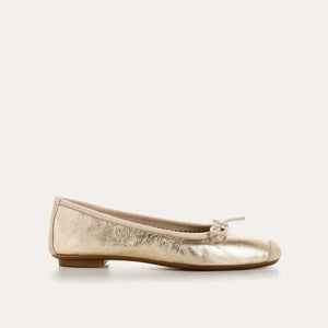 A top view of the REQINS Harmony Bellerina Flat in metallic platinum, featuring a small toe bow and crafted from metallic leather, displayed on a plain light background.