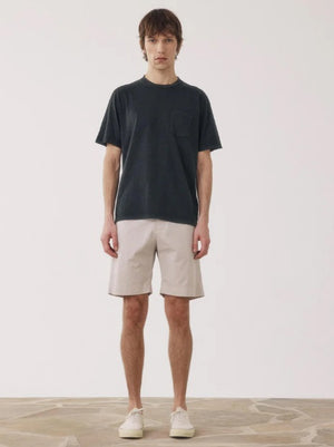 A person models the HARTFORD - TAYLOR SHORTS IN STONE by HARTFORD, shown in light beige against a plain white background. The image is cropped to display only the lower torso and legs.