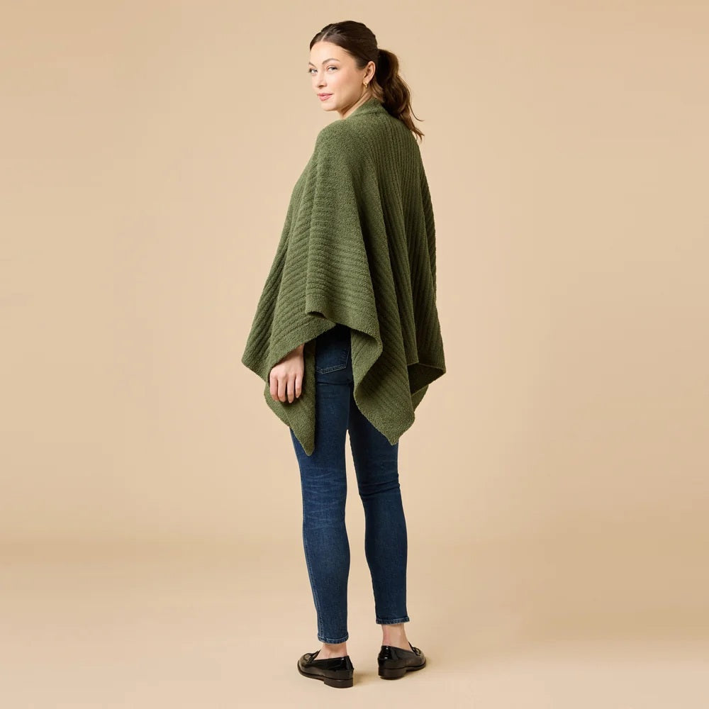 A woman wearing a black SOFTIES - SOLID RIB MARSHMALLOW SHAWL over a grey top and white trousers.