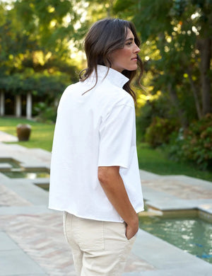 The FRANK & EILEEN Patty Short Sleeve Popover Henley is a plain white collared shirt with a relaxed fit, garment-dyed for softness. It features a subtle v-neck and visible stitching for a casual style.