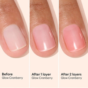 A pink serum drop labeled with its ingredients: raspberry extract (strengthens nails), AHAs (restore and harden), and sweet almond oil (nourishes). The text highlights that MANUCURIST - ACTIVE GLOW CARE POLISH by MANUCURIST INC is 85.5% plant-based—making it the ideal nail strengthener for achieving healthy, glass-like nails.
