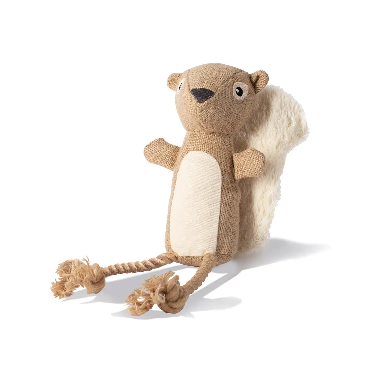 The FRINGE STUDIO - BRING MORE NUTS DOG TOY from PET SHOP BY FRINGE STUDIO is a cute plush squirrel with a light brown body, beige belly, fluffy tail, cartoon eyes, small ears, and rope-like legs with knotted feet, ideal for playtime. Made from recycled materials.