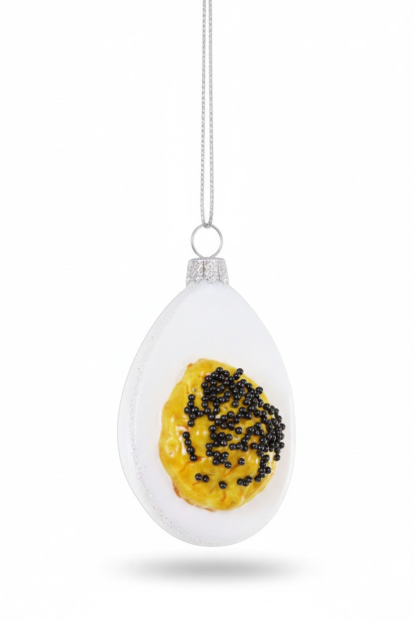 Cody Foster DEVILED EGG WITHG CAVIAR ORNAMENT, a whimsical glass ornament shaped like a deviled egg topped with black caviar.