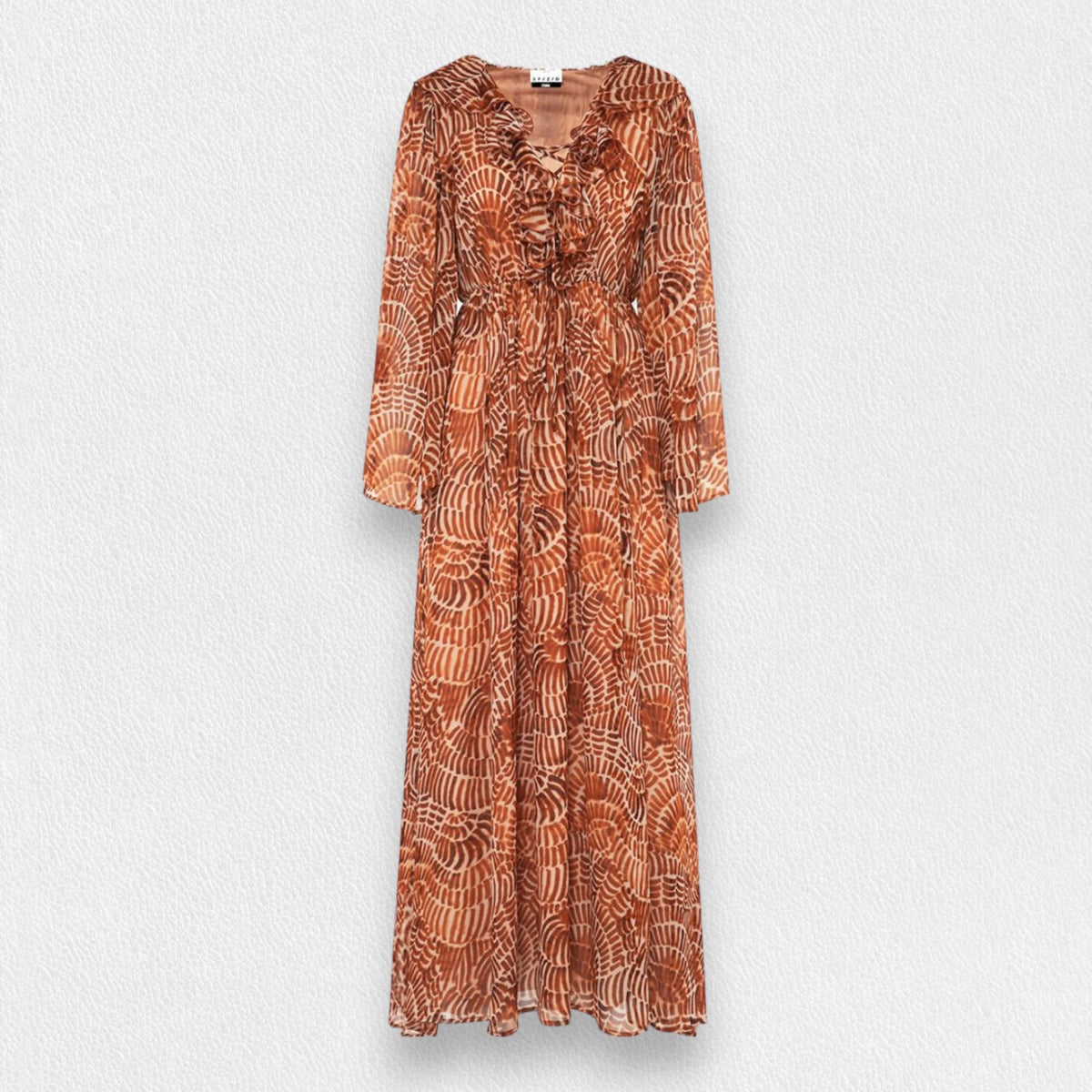 The SFIZIO - RUST PRINT RUFFLED DRESS by SFIZIO is a long, full-sleeved, flowy dress made in Italy, featuring a brown and beige spiral pattern. It boasts a V-neckline, ruffled detailing on the bodice, and an elastic waistband. Crafted from lightweight viscose creponne, it’s perfect for warm weather.