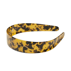 The MACHETE - WIDE HEADBAND by MACHETE is crafted from Italian acetate in a cream hue with dark brown tortoiseshell-style spots. Shown against a white background, this lightweight headband combines stylish design with all-day comfort.