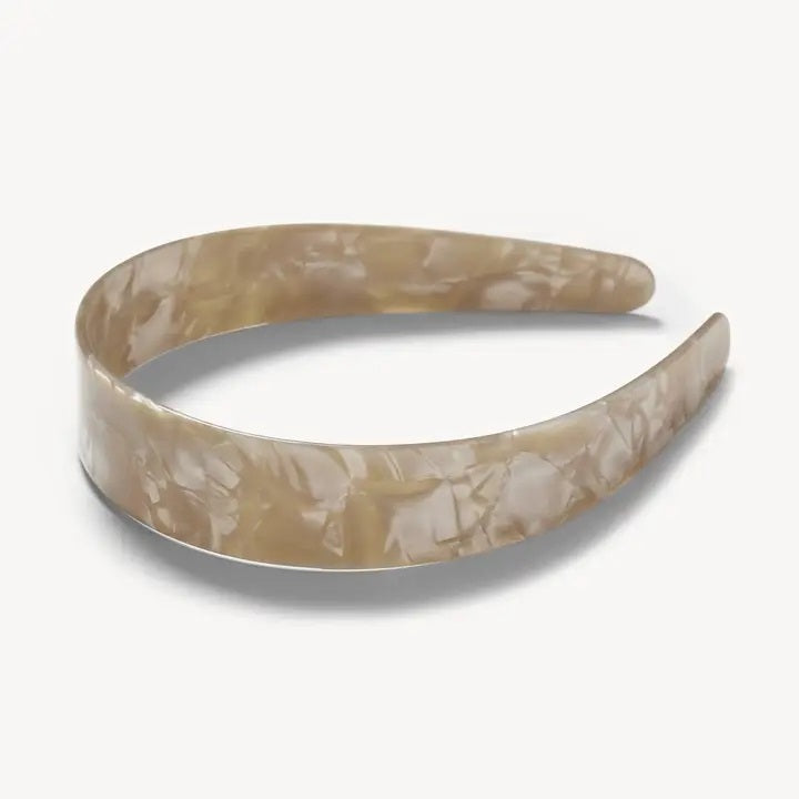 The MACHETE - Wide Headband in Sand Shell by MACHETE is a wide, marbled beige accessory crafted from lightweight Italian acetate with a glossy finish, displayed on a plain white background.