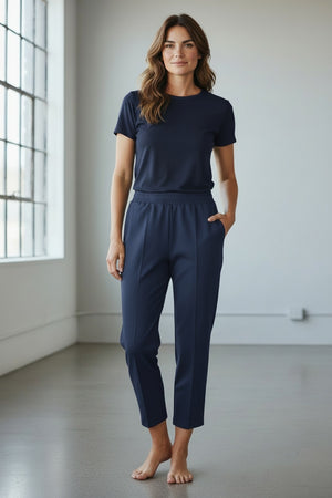 The MEIMEIJ - PONTE PULL ON TROUSER by MEIMEIJ is a pair of light beige, straight-leg trousers with an elastic waistband and side pockets, shown on a plain white background.