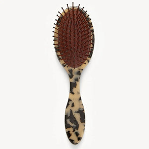 The MACHETE Everyday Detangling Hair Brush in Blonde Tortoise features a tortoiseshell-patterned Italian acetate handle and black-tipped nylon bristles set in a maroon cushion, shown against a plain white background.