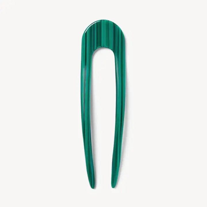A smooth, black MACHETE - FRENCH HAIR PIN with two prongs, crafted from Italian acetate by MACHETE, rests on a plain white surface.