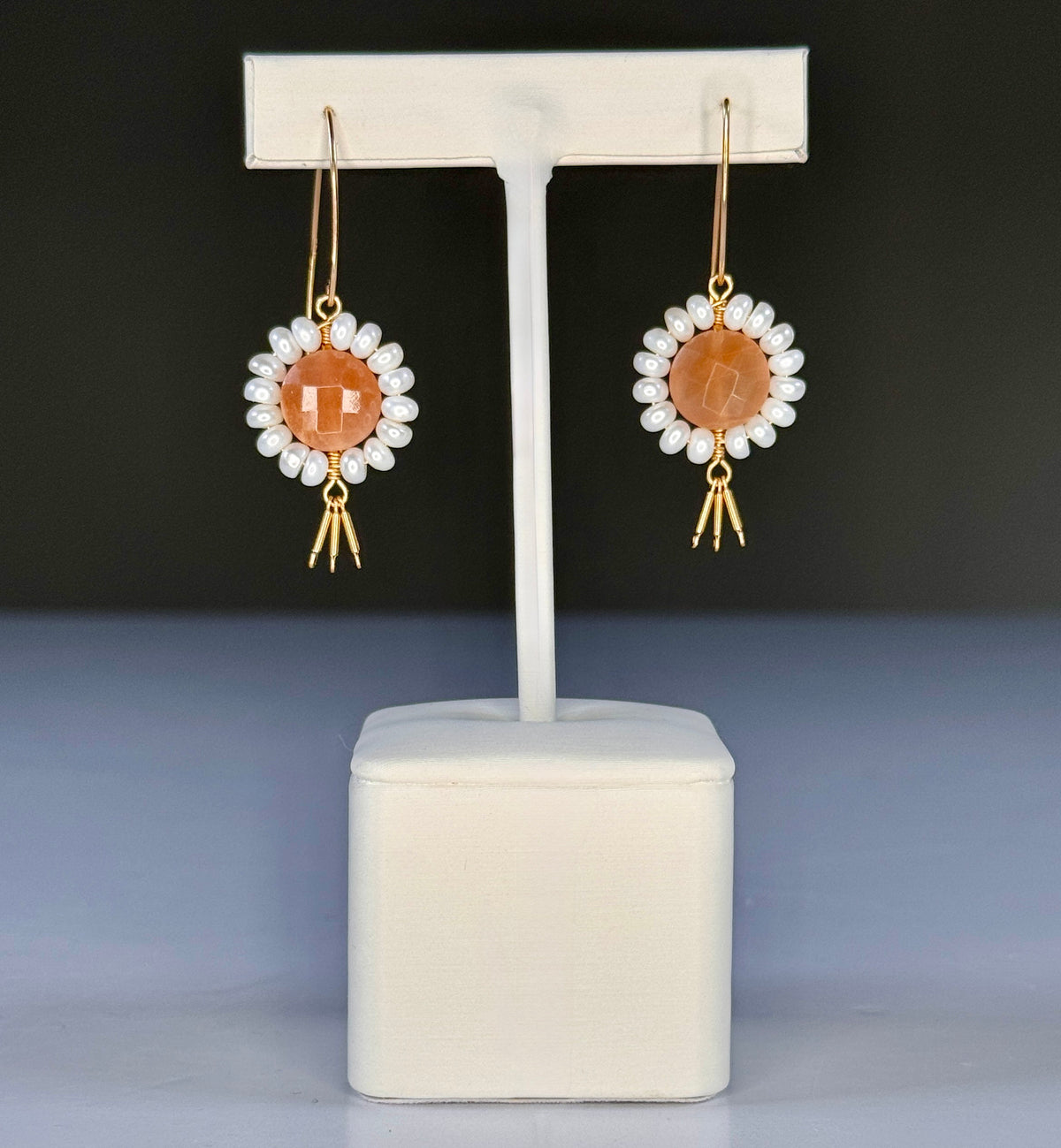 GOLDISH - Floral Gemstone Earrings in Pink Moonstone and White Pearl feature delicate 14K gold fill fringe beneath pink moonstones and white pearls, displayed on a white stand for an elegant look.