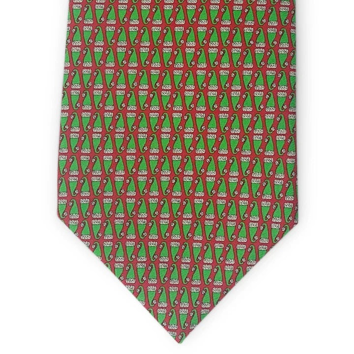 Introducing the BIRD DOG BAY PETER-BLAIR - SANTA HATS SILK TIE IN RED: a handcrafted silk tie adorned with a repeating pattern of festive red Santa hats, set against a vibrant red background. Handmade in New York, this spirited accessory is finished with an exclusive Peter-Blair woven label.