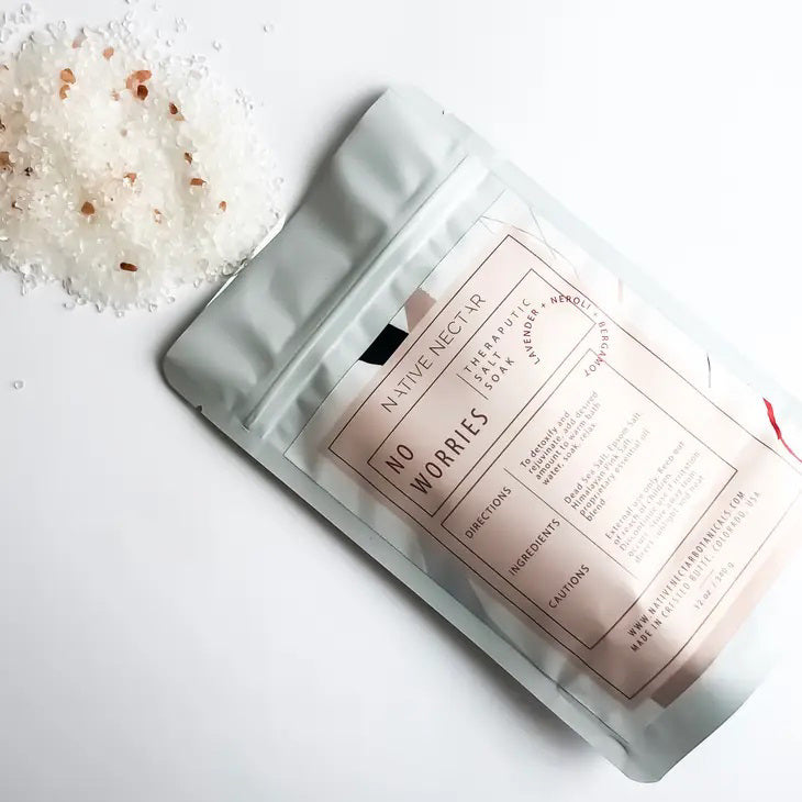 A white stand-up pouch from "Native Nectar" labeled "No Worries Salt Soak" features mineral-rich Dead Sea Salts and contains 12 oz (340g) of product. The packaging, with directions and cautions on the back, aims to reduce muscle soreness and soothe with calming essential oils.