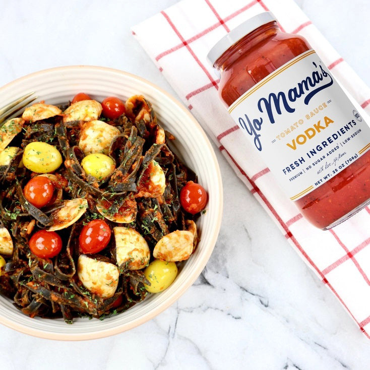 A jar of YO MAMA'S VODKA SAUCE by YO MAMA'S FOODS. The label indicates it's made with fresh ingredients, is all-natural, KETO certified, contains no sugar, and is gluten-free. Handmade in small batches, the jar has a net weight of 25 oz (708g).