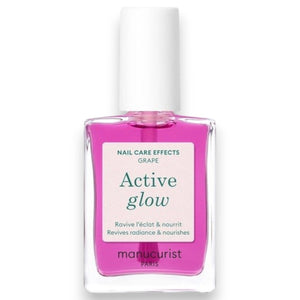 A pink serum drop labeled with its ingredients: raspberry extract (strengthens nails), AHAs (restore and harden), and sweet almond oil (nourishes). The text highlights that MANUCURIST - ACTIVE GLOW CARE POLISH by MANUCURIST INC is 85.5% plant-based—making it the ideal nail strengthener for achieving healthy, glass-like nails.