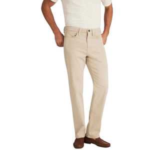 A man with light brown hair and a beard wears a tan blazer, brown sweater, white collared shirt, 34 HERITAGE - CHARISMA RELAXED STRAIGHT LEG PANT IN DAWN TWILL by 34 HERITAGE, and brown shoes against a plain white background.