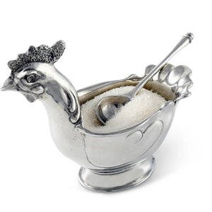 The VAGABOND HOUSE PEWTER HEN SUGAR BOWL WITH SPOON features a luxury-grade pewter chicken-shaped bowl with intricate comb and wattle details, filled with granulated sugar and accompanied by a matching spoon.