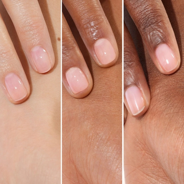 A pink serum drop labeled with its ingredients: raspberry extract (strengthens nails), AHAs (restore and harden), and sweet almond oil (nourishes). The text highlights that MANUCURIST - ACTIVE GLOW CARE POLISH by MANUCURIST INC is 85.5% plant-based—making it the ideal nail strengthener for achieving healthy, glass-like nails.
