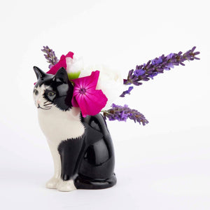 The QUAIL DESIGNS Barney Bud Vase by Quail Ceramics features a black and white cat sitting upright with green eyes and detailed fur, set against a plain white background.
