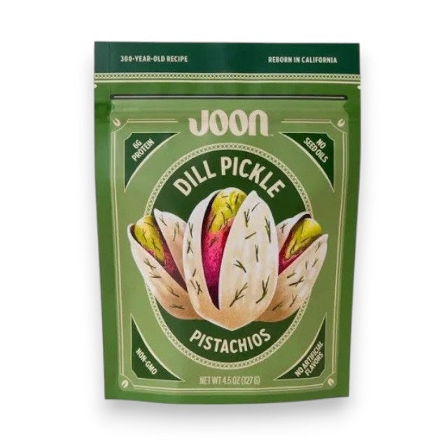 A 4.5 oz (127 g) green bag of JOON DILL PICKLE PISTACHIOS—crafted by JOON as part of their premium snack collection—features a pistachio illustration and highlights “6g protein,” “non-GMO,” “no seed oils,” and “no artificial flavors” on the label. Enjoy these natural snacks from JOON.