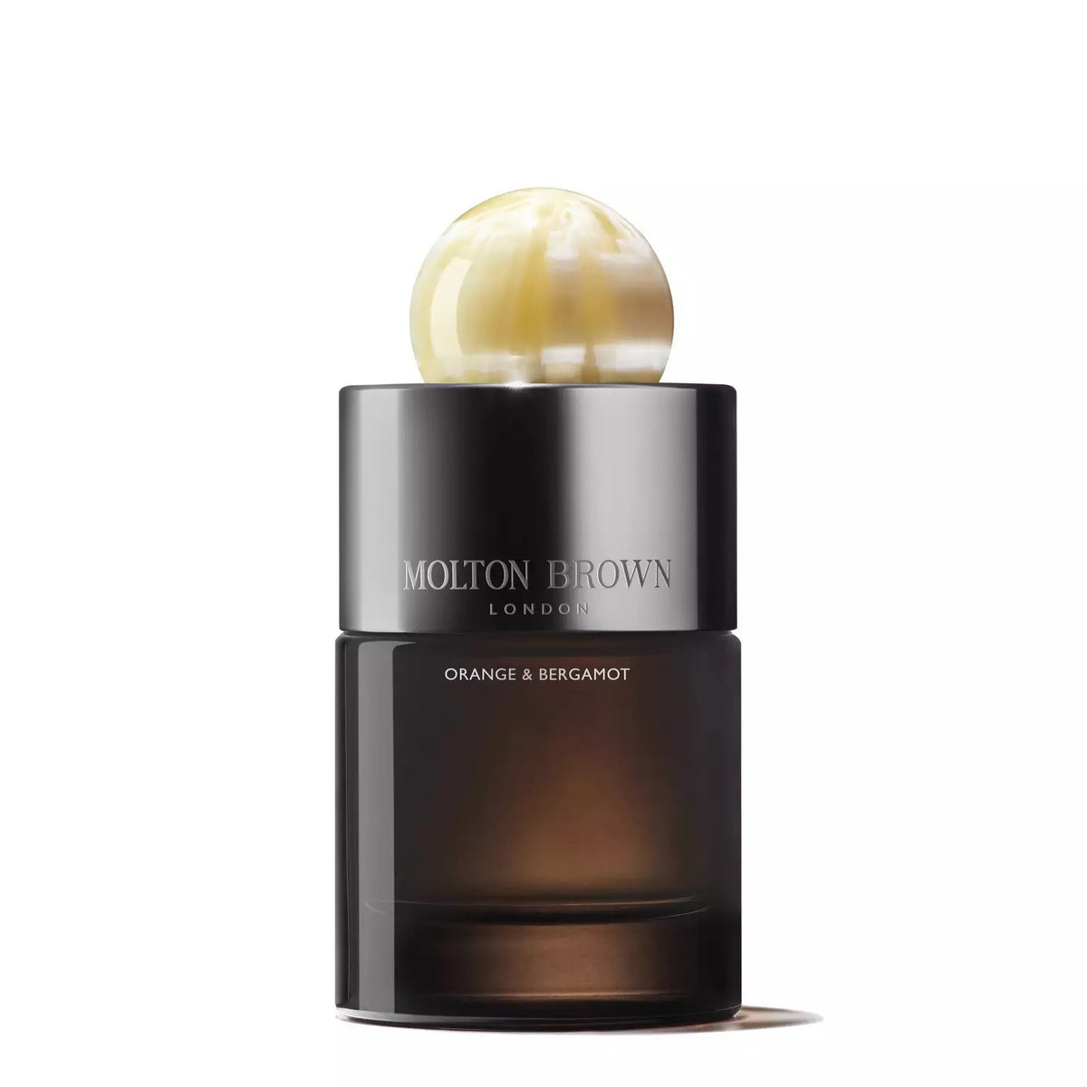 A bottle of MOLTON BROWN - ORANGE AND BERGAMOT EAU DE PARFUM by MOLTON BROWN, featuring a sleek, dark cylindrical design capped with a large, glossy, pearl-like top and exuding aromatic notes reminiscent of blooming orange flowers.