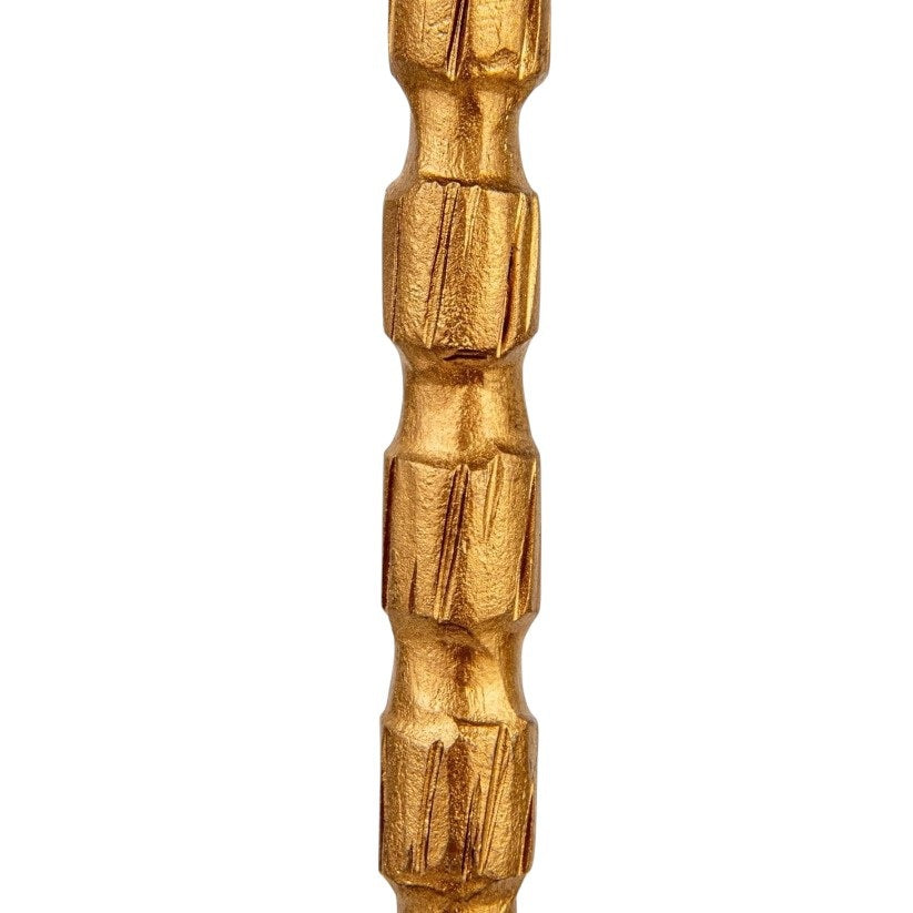 The CREATIVE COOP CAST IRON TAPER HOLDER IN BRASS FINISH, MEDIUM features a sleek, textured stem and round base, bringing elegant style to any setting.