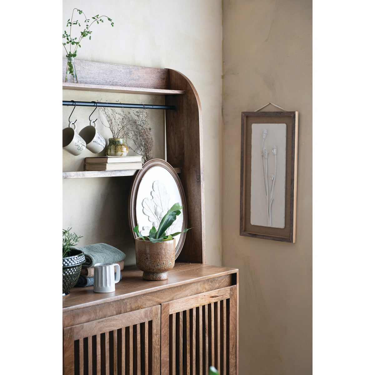 The CREATIVE COOP WOOD FRAMED PLASTER CAST BOTANICAL WITH JUTE MAT features four raised flower stems on a rectangular white panel, adding botanical wall art charm to any room.