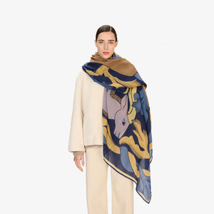 The INOUI CAVALE HORSE WOOL SCARF in navy features an abstract design with stylized tan and lavender rabbits among blue and yellow leafy shapes, all set against a dark blue background.