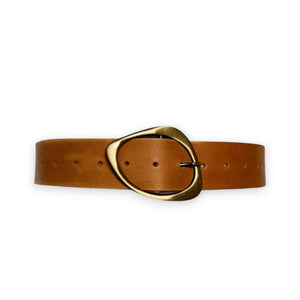 The LUXE LEATHER BELT by ADA is handmade by artisans from genuine Argentinian leather. It features a large oval brass buckle and multiple holes for adjustability, elegantly displayed against a white background.