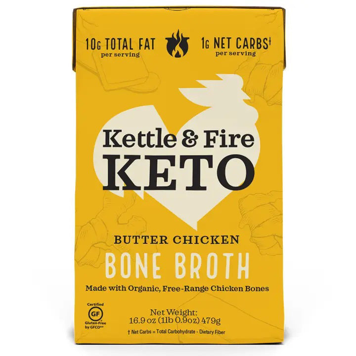 A yellow carton of KETTLE &amp; FIRE - BUTTER CHICKEN KETO BONE BROTH is shown. Nutritional information includes 10g total fat and 1g net carbs per serving. Made from organic, free-range chicken bones and grass-fed butter, it boasts a velvety-smooth finish. The net weight is 16.9 oz (479g) and it's labeled gluten-free.