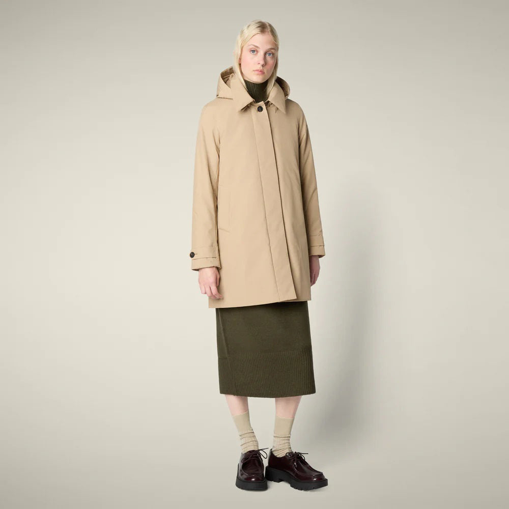 The SAVE THE DUCK - EMBIE COAT is a light beige, mid-length women&#39;s raincoat by SAVE THE DUCK, made from waterproof recycled polyester with a hood, buttoned front, side pockets, and adjustable cuffs. Shown on a plain white background.