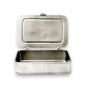The MATCH - TUTTO E POSSIBILIE BOX LARGE by MATCH features a pewter box engraved with “TUTTO E POSSIBILIE” inside the lid, containing a heart-shaped chocolate and a small rolled paper tied with a green ribbon—an inspiring gift for any occasion.