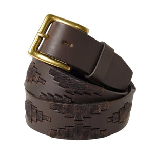 The LA MATERA - CASTANO POLO BELT by LA MATERA, featuring a dark brown leather embossed geometric design and brass buckle, is handcrafted in Argentina and coiled neatly against a plain white background.