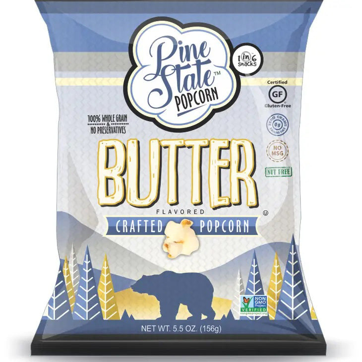 A 5.5oz bag of PINE STATE - BUTTER POPCORN by 1 IN 6 SNACKS, featuring buttery flavor, bear and pine tree design, and labels for gluten-free, non-GMO, and 100% whole grain.