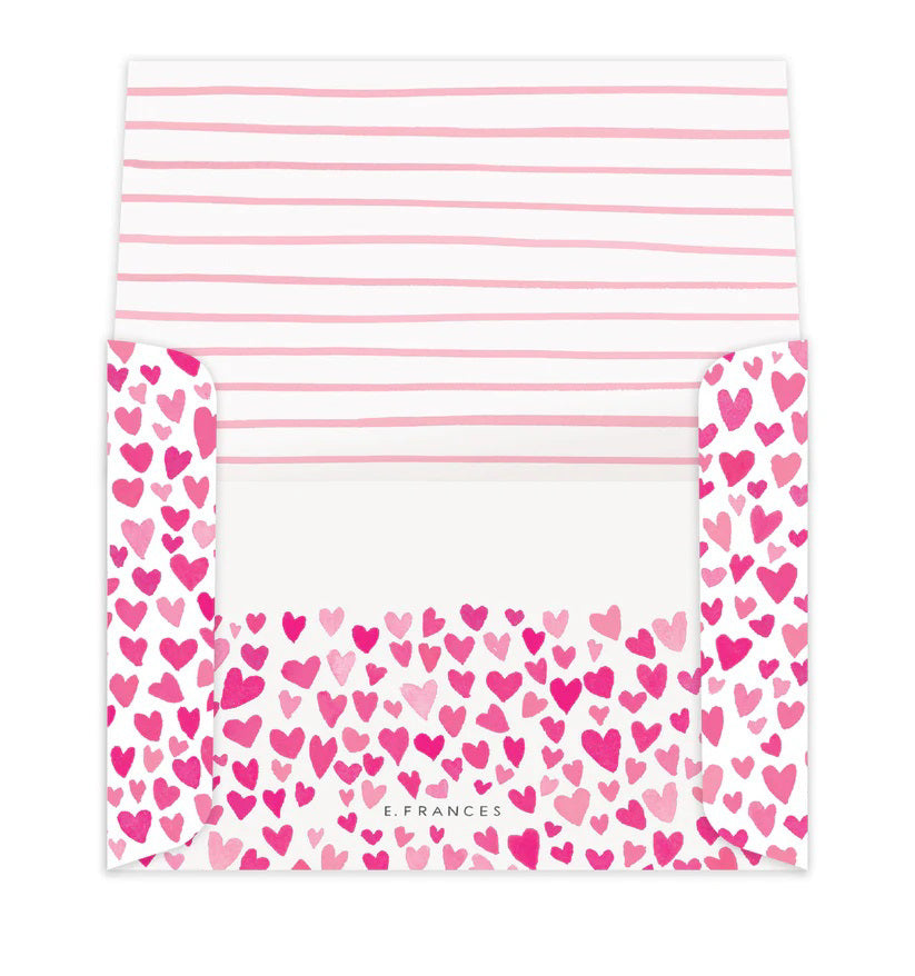 The E. FRANCES PAPER - DOGGIE DRESS-UP CLASSROOM VALENTINE SET features three dogs dressed festively: one in striped pajamas, another with a heart bandana, and a third with heart antennae. “Happy Valentine’s Day!” is displayed across the top against a backdrop of pink hearts, ideal for charming Valentines or envelopes.